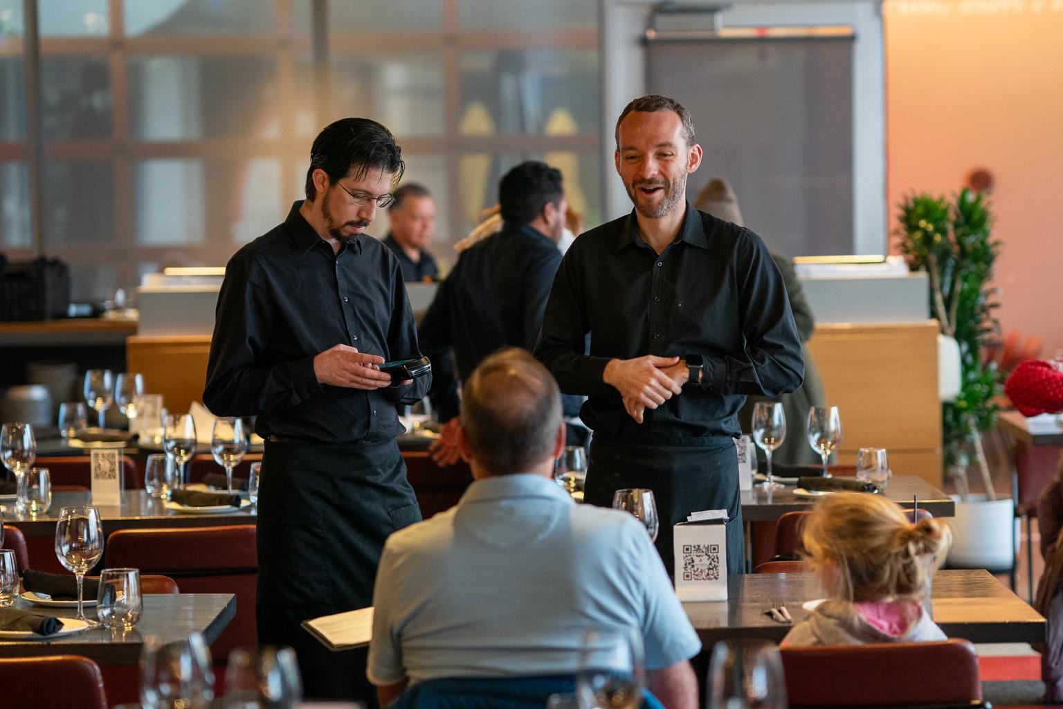 Server Ben Moser, at right, with a customers at Cattivella.