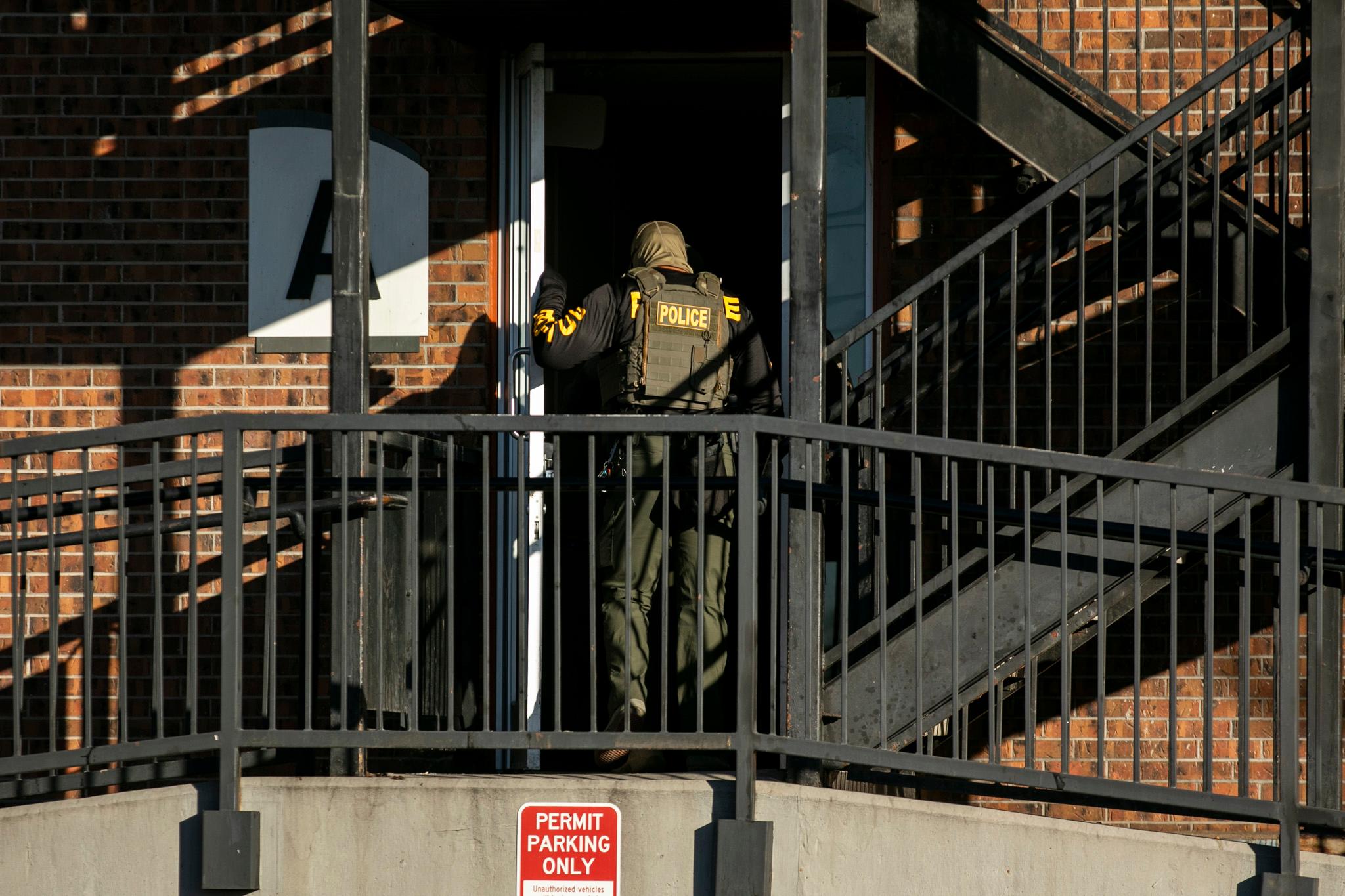 Federal law enforcement outside the Cedar Run Apartment