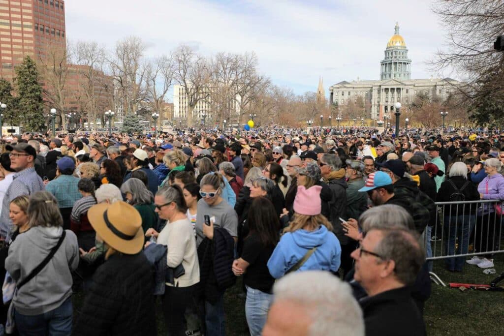 A sea of thousands of people in Civic Center Park. The Capitol is in the background.
